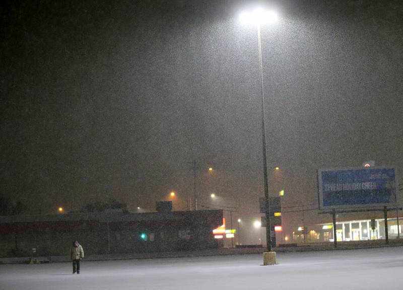 A pedestrian walks through the snow on Monday Jan. 8, 2024 along North Main Street in Princeton.