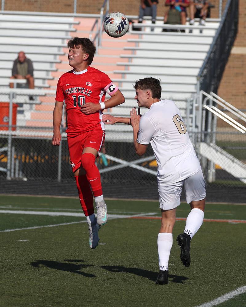 Yorkville's Wyatt Panczuk and Sycamore's Tyler Hiland head the ball Thursday, Aug. 28, 2025, during their game in the Barb Cup tournament at DeKalb High School.