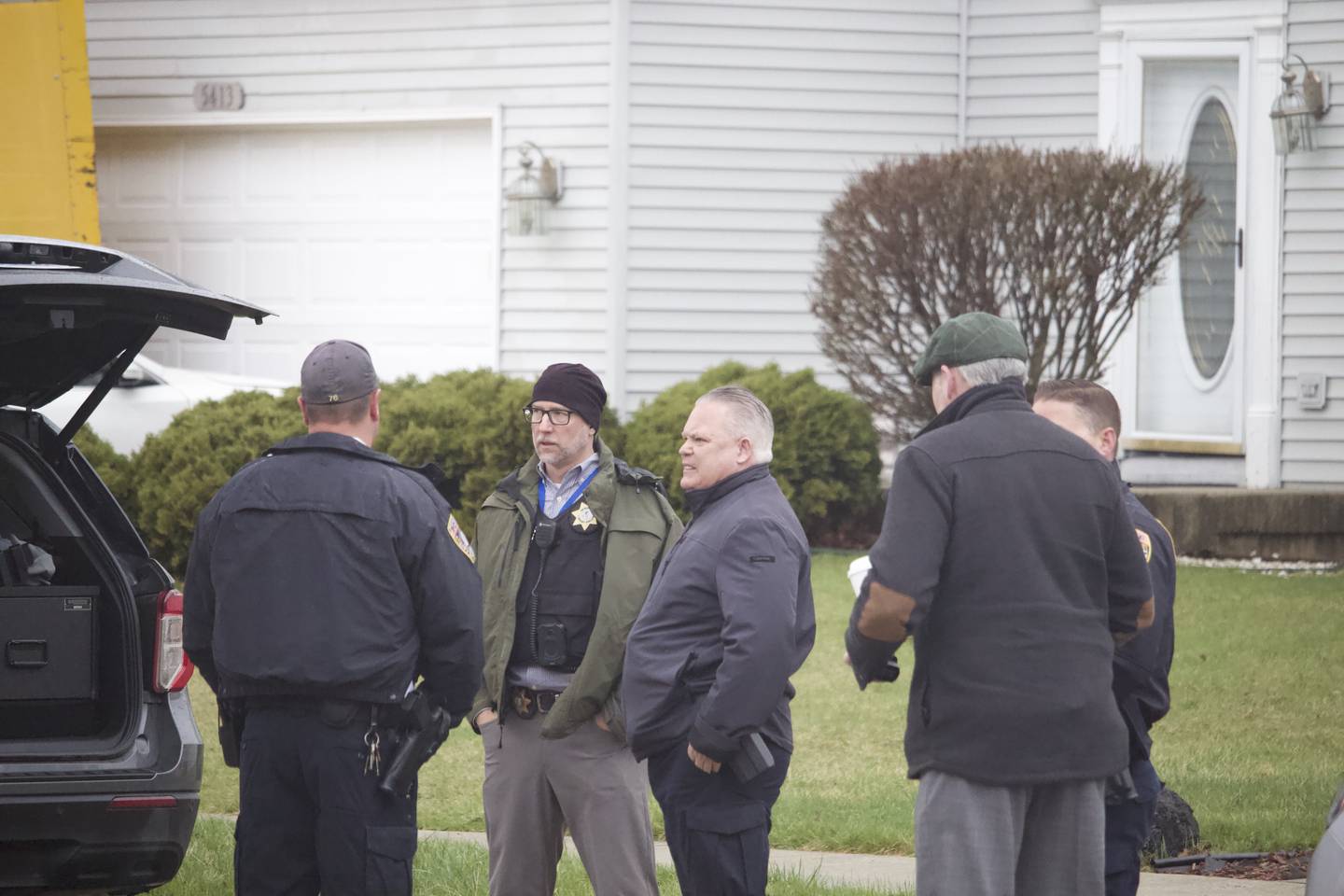Joliet Police Chief Bill Evans (center) stands with other officers and detectives on April 2, 2025, in the area of Meadowbrook Street and Lasser Drive in the far west side of joliet.