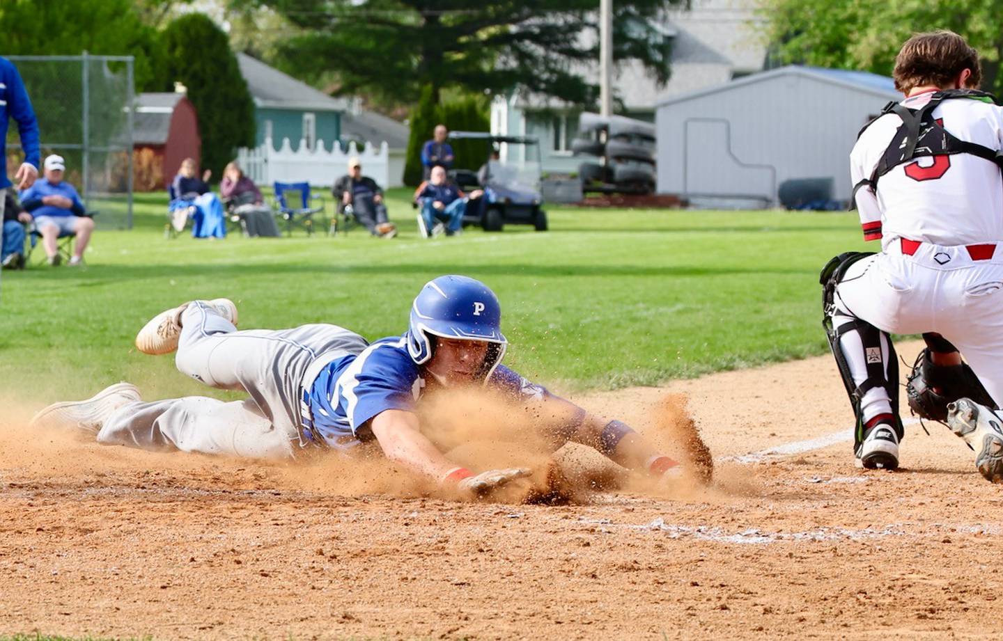 Princeton's Will Lott slides in safely as Hall catcher Greyson Bickett takes the throw to home Monday at Prather Field. The Red Devils won 10-4.