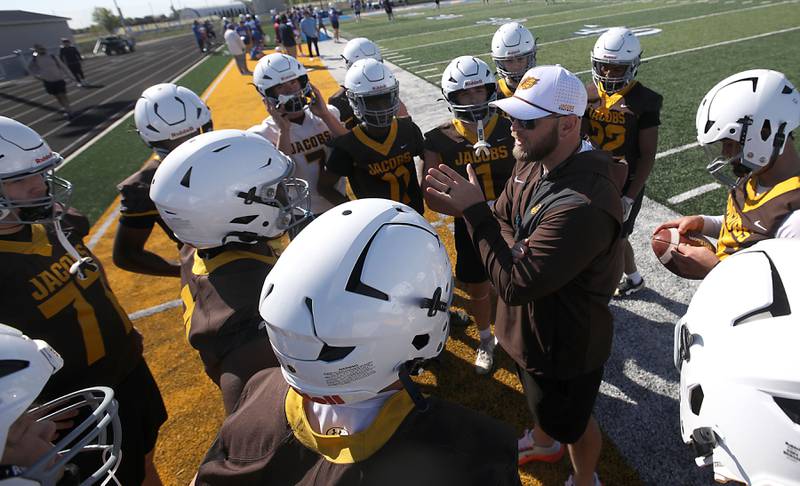 Jacobs coach Samuel Baker talks to players before the start of the Northern Burbs Football Showcase on Monday, May 4, 2026, at Johnsburg High School. Over 165 players from 15 teams demonstrated their football skills to over 60 college coaches.