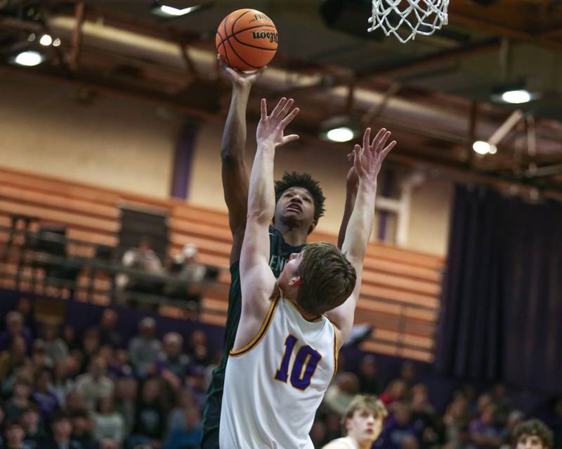 Glenbard West's Logan Glover (20) puts up a one handed shot during their basketball game between Glenbard West at Downers Grove North. Jan 24, 2025 in Downers Grove.