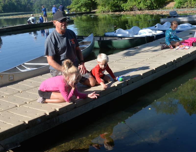 Ryan Wilkens of Morrison helps his grandchildren Emma and Andrew Deboer, 7 and 3, fish from one of the docks at the Whiteside County Sheriff Office and Mounted Patrol's annual fishing derby at Morrison-Rockwood State Park in Morrison on Saturday, Sept. 9, 2023.