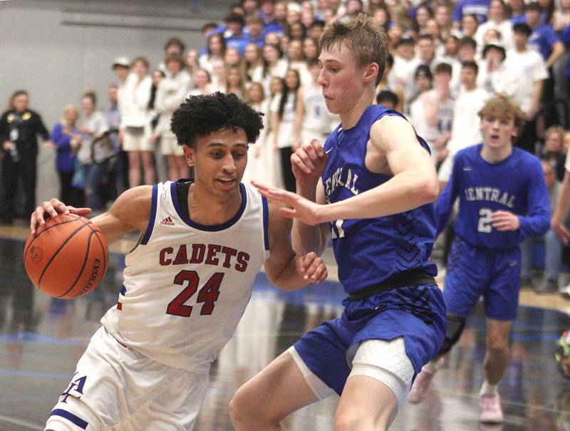 Burlington Central’s Drew Scharnowski guards Marmion Academy’s Trevon Roots in IHSA Class 3A Sectional title game action at Burlington Central High School Friday night.