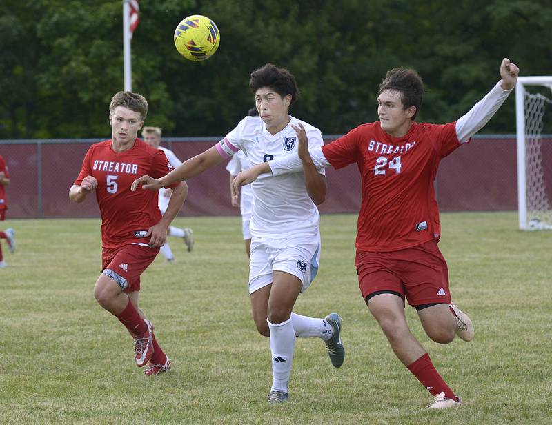 Streator’s Brenden Fleming and Keegan Gassman battle Plainfield South’s Xavier Martinez work for control of the ball in the 1st half during match Tuesday at Streator.