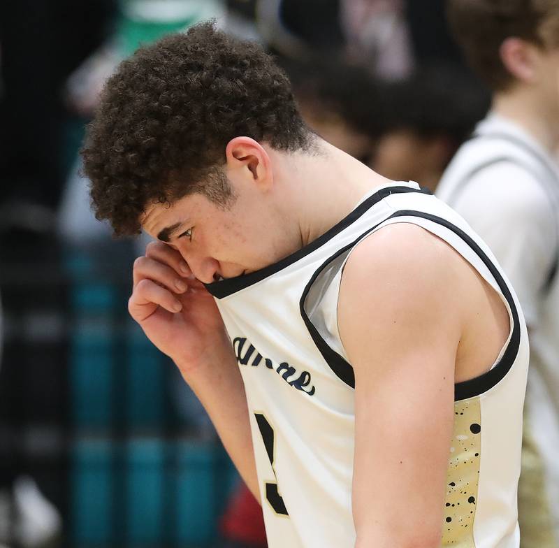 Sycamore's Marcus Johnson wipes his eyes after Sycamore lost to Crystal Lake South in an IHSA Class 3A Woodstock North Sectional semifinal.basketball game on Wednesday, March 4, 2025, at Woodstock North High School.