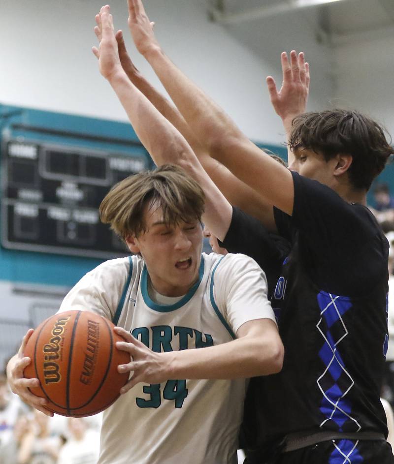 Woodstock North’s Tyler Ward drives to the basket against Woodstock's Spencer Cullum during a Kishwaukee River Conference boys basketball game on Friday, Jan. 5. 2024, at Woodstock North High School.