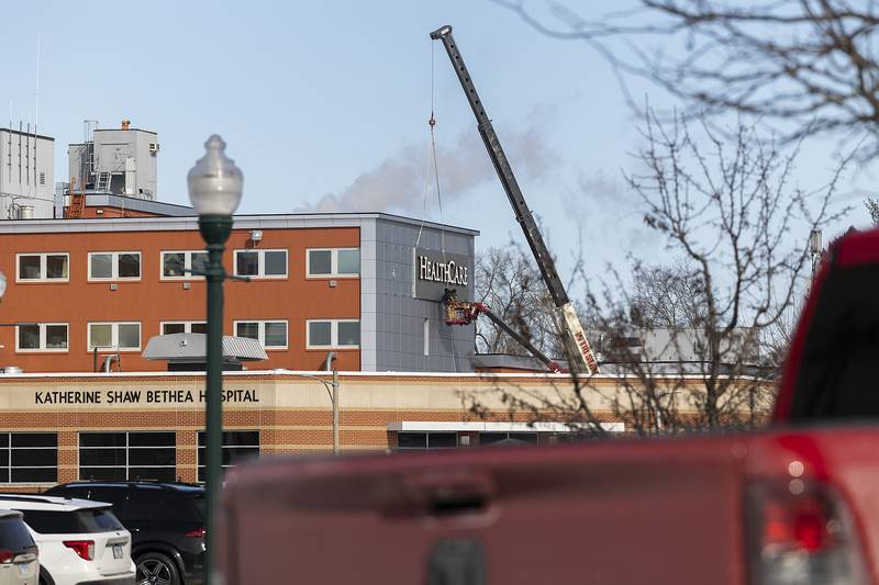 Workers begin to install new signage at the former KSB Hospital in Dixon on Tuesday, Feb. 18, 2025. OSF HealthCare merged with the hospital Jan. 1.