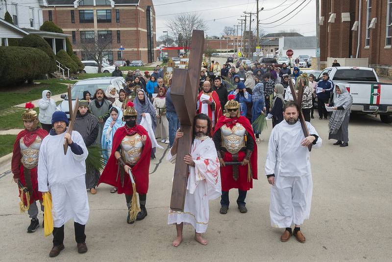 A stations of the cross procession leaves Sterling’s St. Mary’s church on Good Friday, April 15, 2022 and heads west on Sixth Street where they reenact the last moments of Jesus’ life.