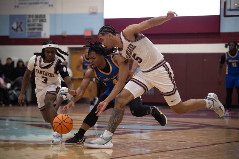 Kankakee's Cedric Terrell III, left, and EJ Hazelett, right, try to contain a loose ball over Crete Monee's Zyheir Gardner, center, in a game on Friday, January 9, 2026.