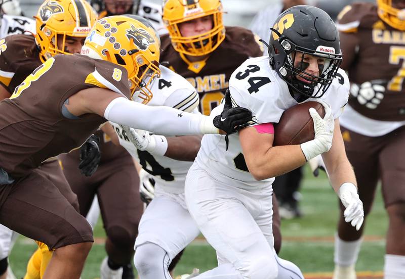 Sycamore's Joey Puleo pulls away from Carmel's Harlon May on his way to a touchdown during their Class 5A second round playoff game Saturday, Nov. 5, 2022, at Carmel Catholic High School in Mundelein.