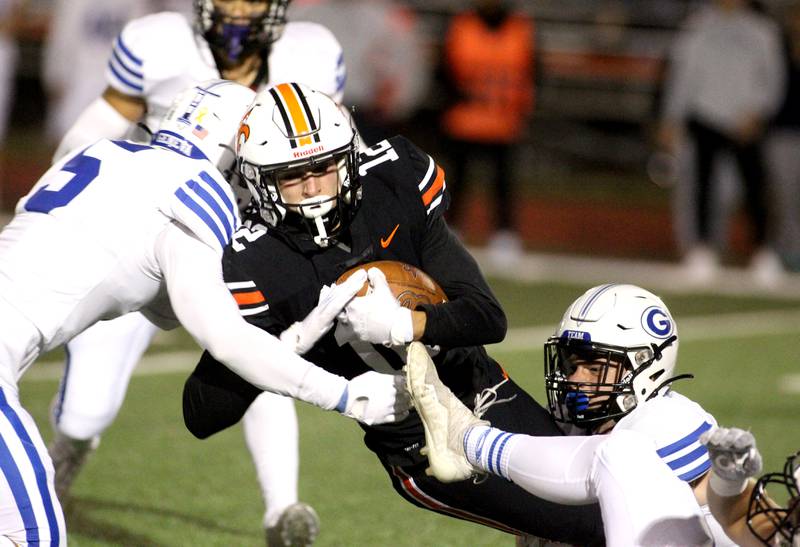 St. Charles East’s Mason Tousignant (12) carries the ball during a home game against Geneva on Friday, Sept. 30, 2022.