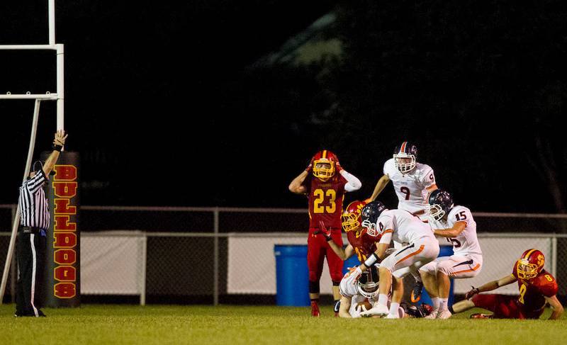 Oswego players rejoice while Batavia is in shock after Joseph Hennessy's game-winning touchdown reception with no time on the clock Saturday at Bulldog Stadium in Batavia.