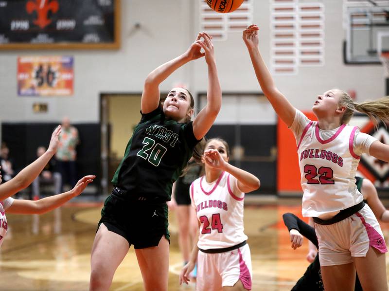 Glenbard West's Ellie Noble and Batavia's Ali Thomas  go after a rebound during the Class 4A St. Charles East Sectional final on Thursday, Feb. 27, 2025 in St. Charles.