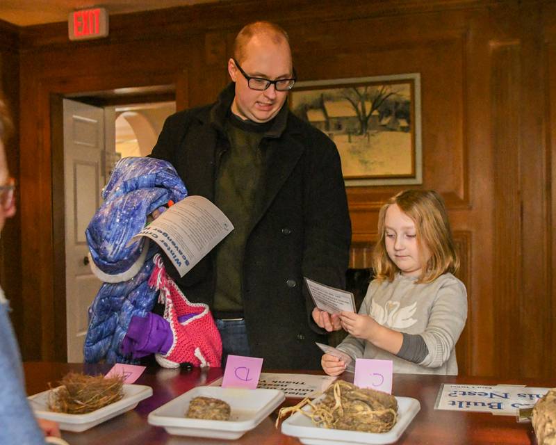 Eric Davis and daughter Hannah, 7, of Batavia try to match up the bird nests from the informational cards provided during the Polar- Palooza event on Saturday Jan. 17, 2026, held at Creek Bend Nature Center in St. Charles.