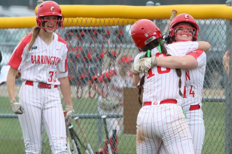Barrington’s Ellie Wintringer, right, embraces teammate Emma Kavanagh after Kavanagh scored on Wintringer’s sacrifice to give the Fillies a seventh-inning lead during the Class 4A Huntley Sectional championship, Saturday, June 4, 2022.