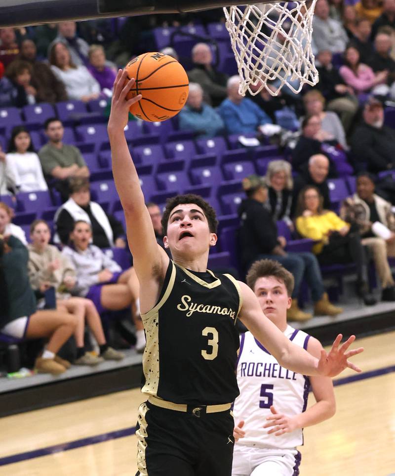 Sycamore's Marcus Johnson gets to the basket ahead of Rochelle's Mason Ludwig Friday, Dec. 5, 2025, during their game at Rochelle High School.