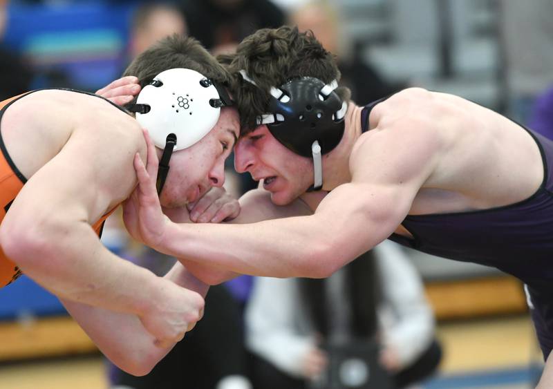 Dixon's Steven Kitzman (right) locks up with Winnebago's  Charley Murray in a 179-pound match at the 1A Wrestling Regional at Eastland High School on Saturday, Feb. 4.
