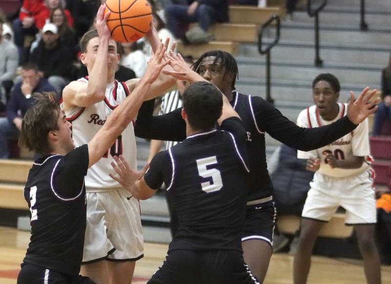 Huntley’s Brady Hassels navigates heavy traffic against Hampshire in varsity boys basketball on Friday, Dec. 19, 2025, at Huntley High School in Huntley.