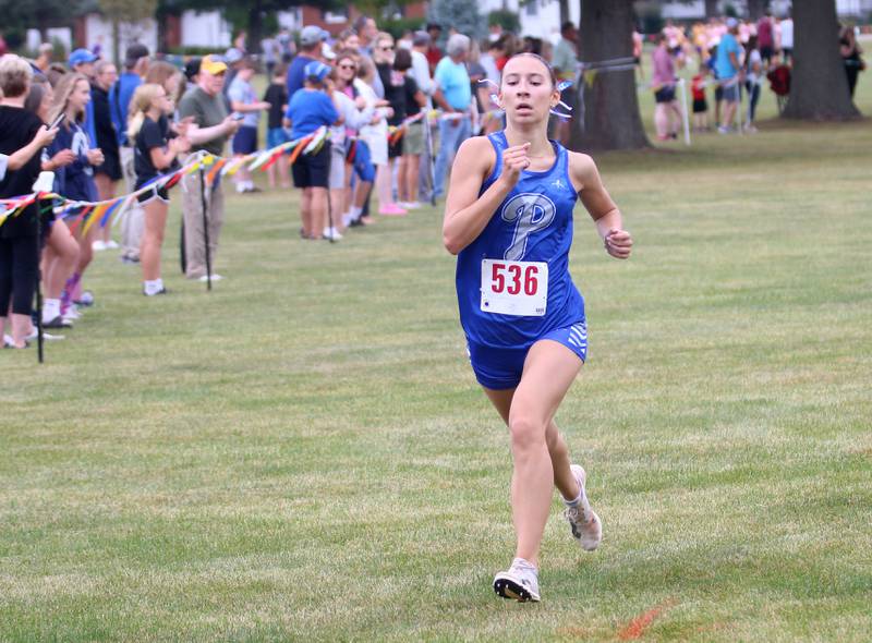 Princeton's Ruby Acker competes during the Gary Coates Invitational cross country meet on Saturday, Sept. 13, 2025 at Zearing Park in Princeton .