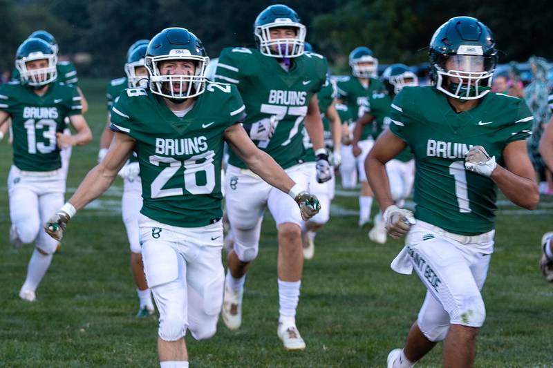 Brody Burris (28) of St. Bede runs onto field with excitement on Friday, Sept 12, 2025 at Captain Thomas J. Heitmann field in Peru.