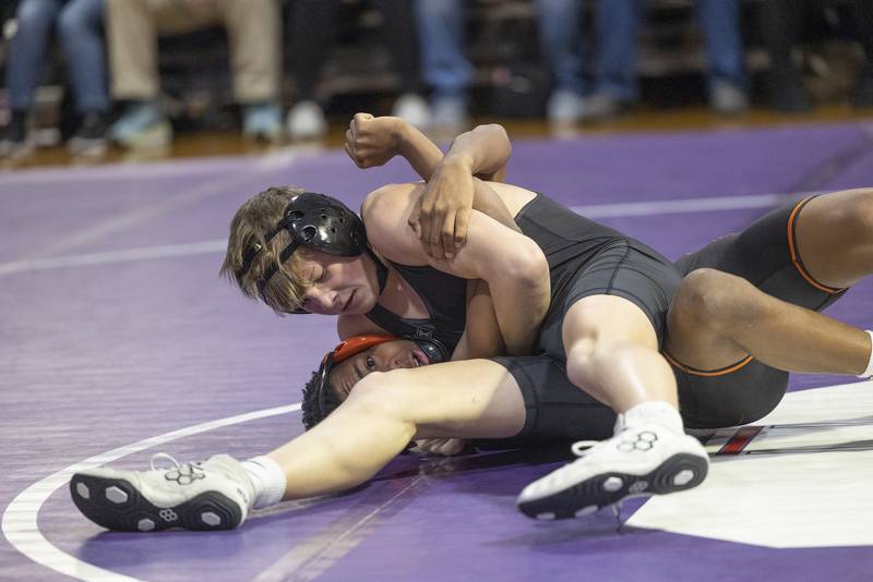 Dixon’s Kaz Barber goes for the pin against Freeport’s Braylon Cain Tuesday, Jan. 13, 2025, during a triangular meet with Sterling at Dixon High School.