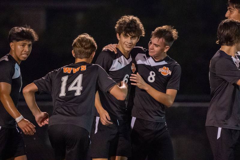 Wheaton Warrenville South's Chase Kedzior (6) is congratulated by Christian Triscik (8) and Brooks Becker (14) after scoring a goal against Geneva during a soccer match at Wheaton Warrenville South on Tuesday, Sep 13, 2022.