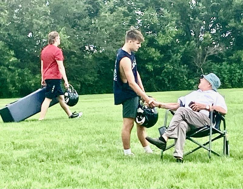 Bureau Valley senior Tucker Shane meets Hall of Fame coach John Elder, the father of new Storm coach Patrick, at the conclusion of Monday's first day of the Storm Camp.