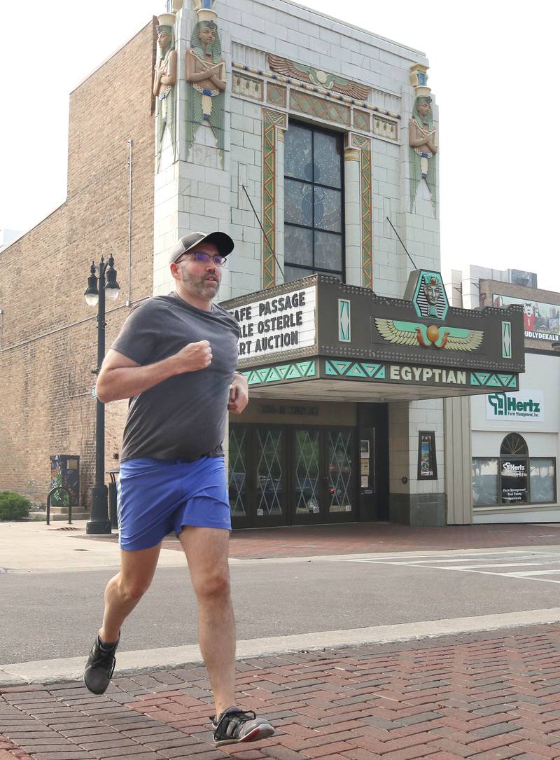Shawn Beck, from DeKalb, runs Wednesday, June 28, 2023, past the Egyptian Theatre on Second Street in DeKalb. Beck recently completed his goal of running every street in DeKalb County.