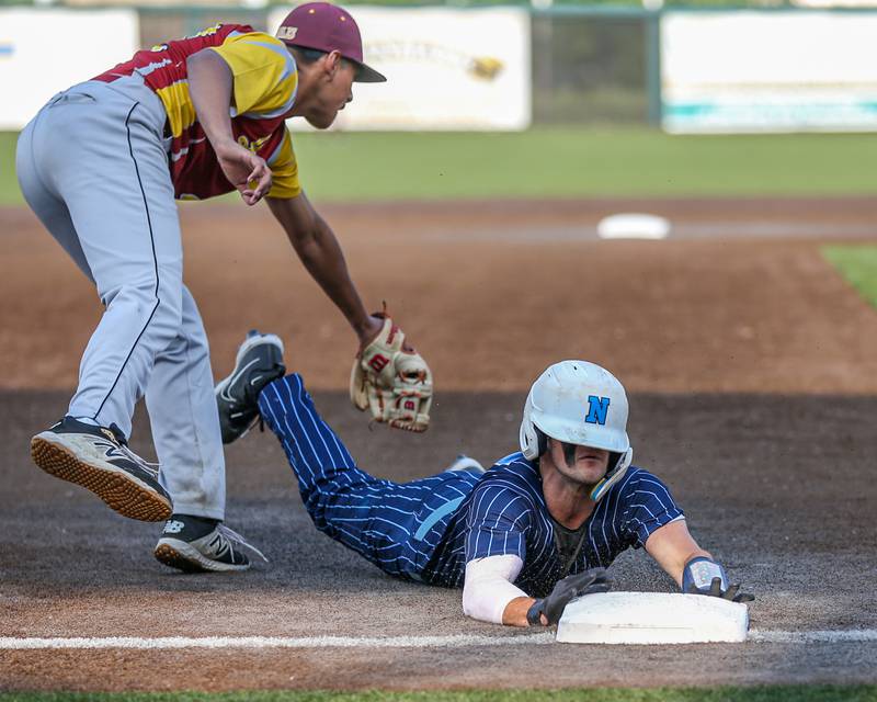 Nazareth's David Cox (27) slides under the tag into third base during Class 3A Crestwood Supersectional game between Lindblom at Nazareth.  June 5, 2023.