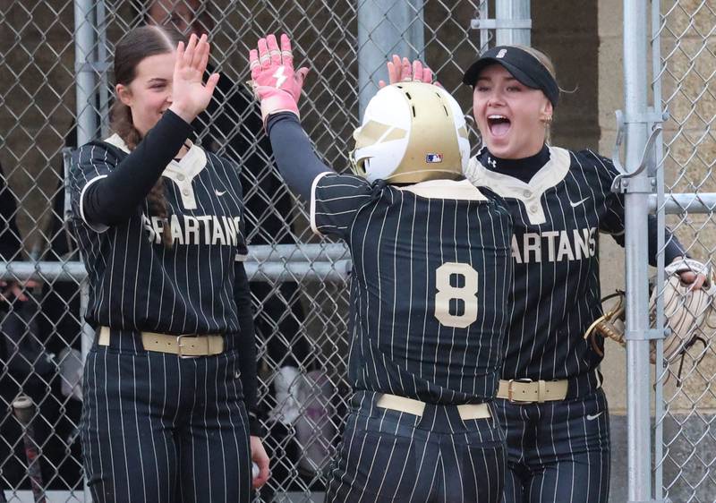Sycamore's Bella Jacobs (middle) celebrates with teammates after scoring the first run of the game Thursday, April 30, 2026, against LaSalle-Peru at Sycamore High School.