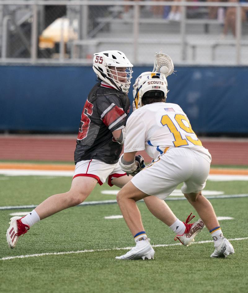 Huntley's Andrew Baumley pushes past Lake Forest defender Lucas Kroner during the boys lacrosse supersectional match on Tuesday, May 31, 2022 at Hoffman Estates High School.