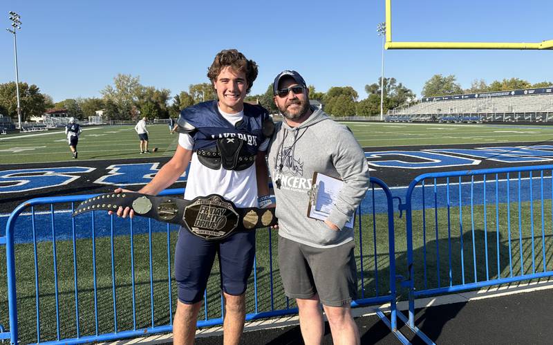 Lake Park wide receiver Niko Menos (left) and football head coach Chris Kirkpatrick pose with the Friday Night Drive MVP belt.