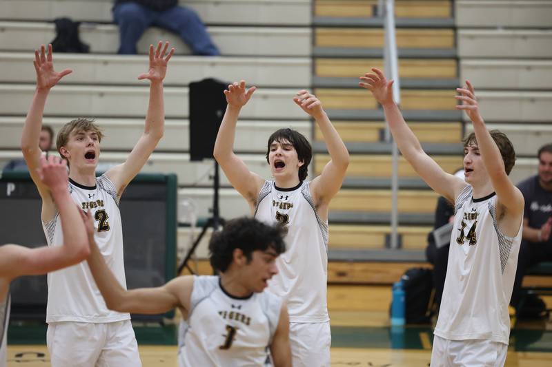 Joliet West’s Landon Brouwer, left, Nolan Fellows, Thomas Fellows celebrate a point against Plainfield Central on Tuesday, April 23, 2024 in Plainfield.