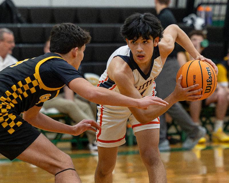 Pedro Lopez (1) of DePue holds ball as Chase Isaac (4) of Reed-Custer guards him during game in the Shipyard Showdown on Tuesday, December 23, 2025 at Seneca High School in Seneca.