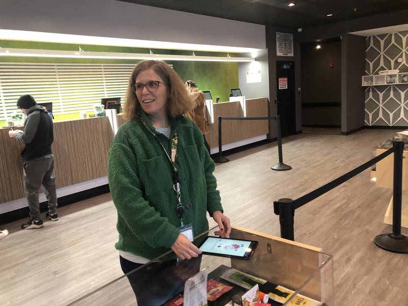 Emily Jones, a budtender at EarthMed McHenry, helps patrons shop for their recreational marijuana on Wednesday, Dec. 20, 2023. The store opened Friday, and held a ribbon cutting Wednesday.