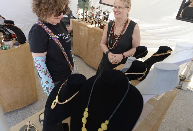 Mitzi Grey of Addison talks with artist Deborah Kerr of Chicago during the LaGrange Art Festival Saturday, Sept. 9, 2023.