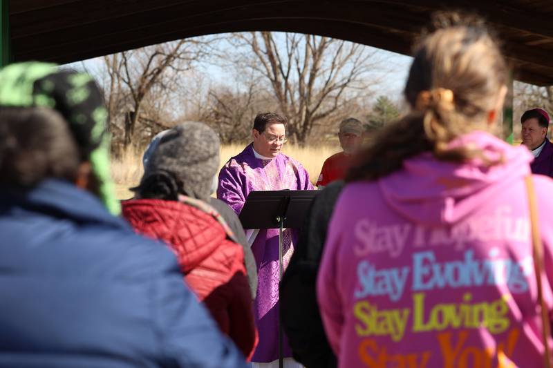 Rev. Matt Pratscher, of St. John Paul II Catholic Church, helps lead a Mass and prayer service held in Aroma Park on Thursday, March 12, 2026, following the EF-3 tornado that tore through the town and Kankakee County on March 10.