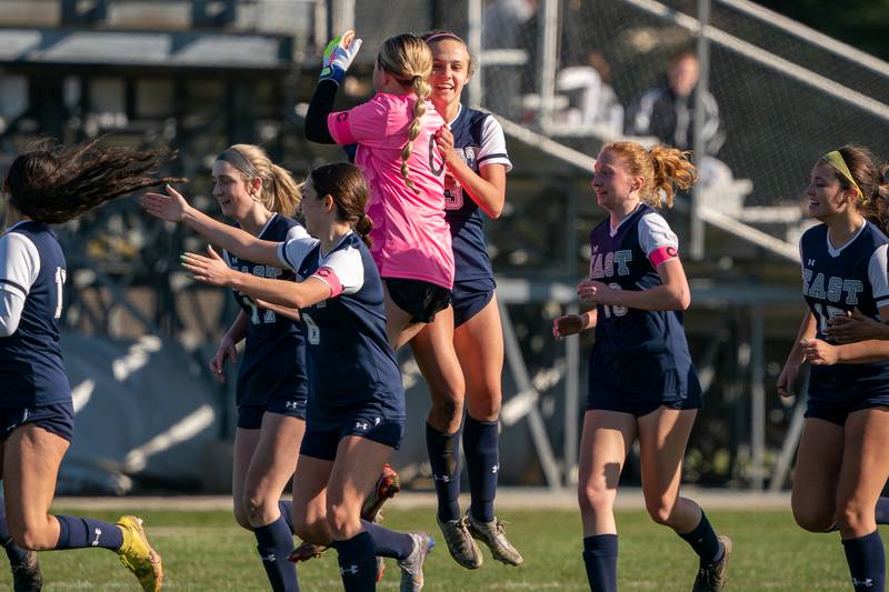 Oswego East's Samantha McPhee (0) celebrates with Oswego’s Gillian Young (3) after Young scores a goal against Oswego during a soccer match at Oswego East High School on Thursday, Apr 6, 2023.