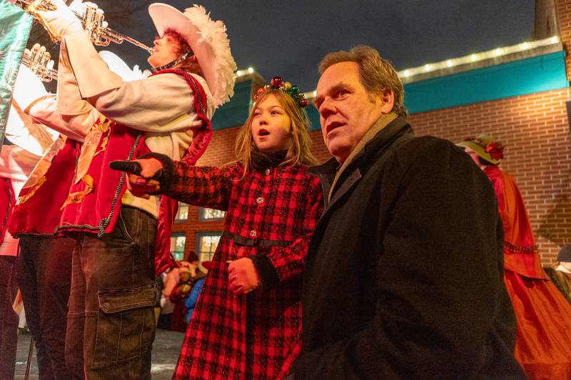 Geneva's Mayor Kevin Burns talks with the candy cane delivery girl at the Annual Geneva Christmas Walk on Friday, Dec. 5, 2025 in Geneva.