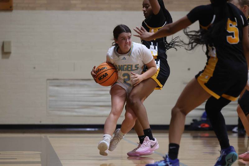 Joliet Catholic’s Madeline Moran works the ball along the baseline against Marian Catholic on Monday, Dec. 9, 2024 in Joliet.