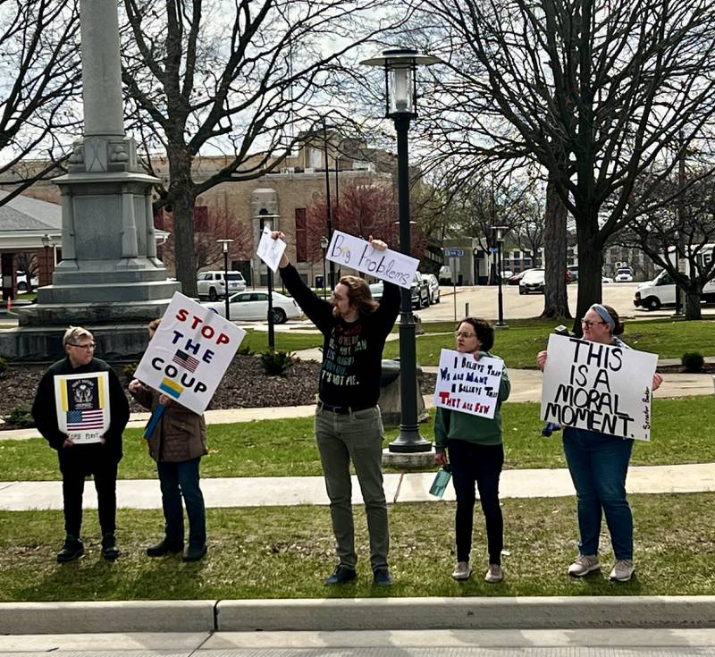 Protestors gather in front of the Grandon Civic Center and the post office on Saturday, April 5, in Sterling to voice concerns over President Donald Trump and his administration.