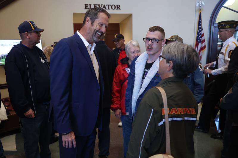 New Lenox Mayor Tim Baldermann, left, talks with Marine Corps veteran Patrick Bain and his mother Kimberly Engvall at the Veterans Day event at the New Lenox Village Hall on Monday, Nov. 11, 2024.