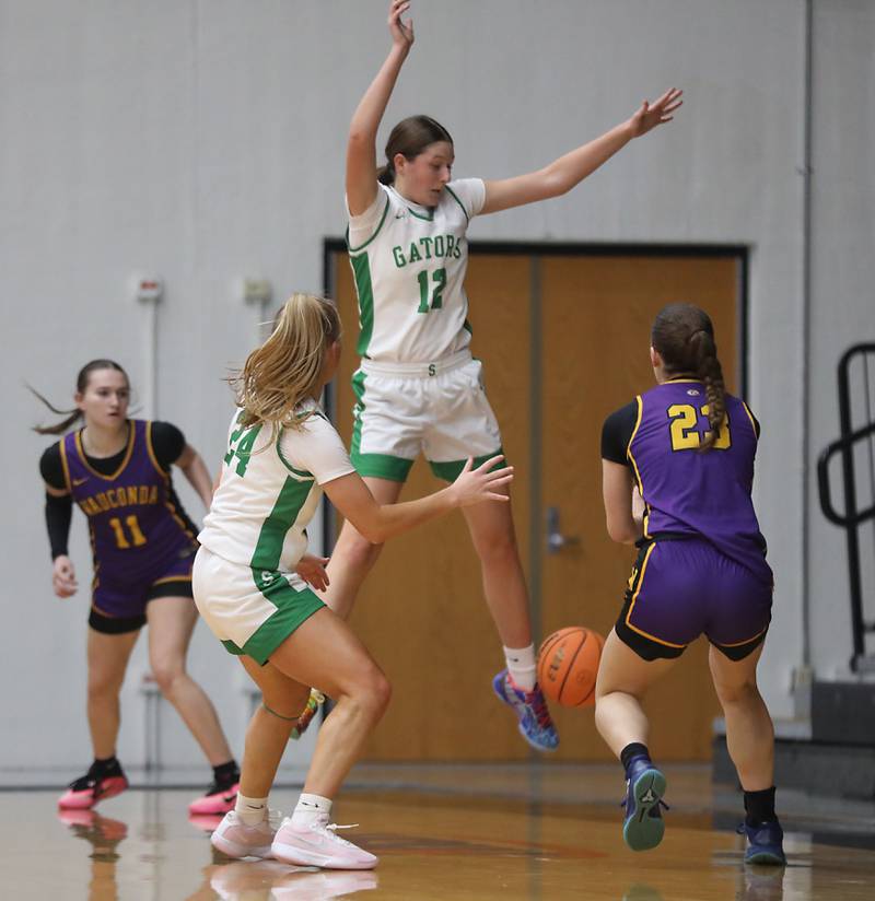 Crystal Lake South's Gaby Dzik (center) kicks the ball away as she and Gracey LePage guards Wauconda's Sarah Palmer (right) during the Northern Illinois Holiday Classic Championship girl basketball game on Thursday, Dec. 18, 2025, at McHenry High School.