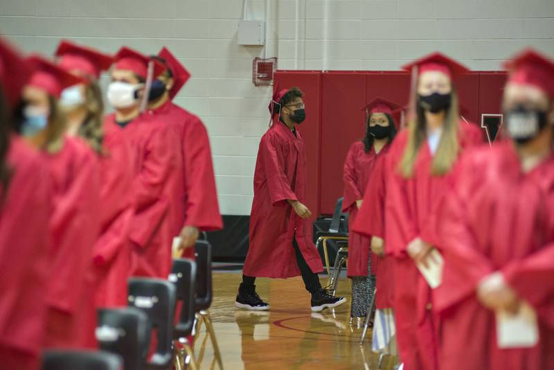 Graduates file into the gym Friday night for the 2021 commencement ceremony at Sauk Valley College. Last year's graduation was completely virtual.