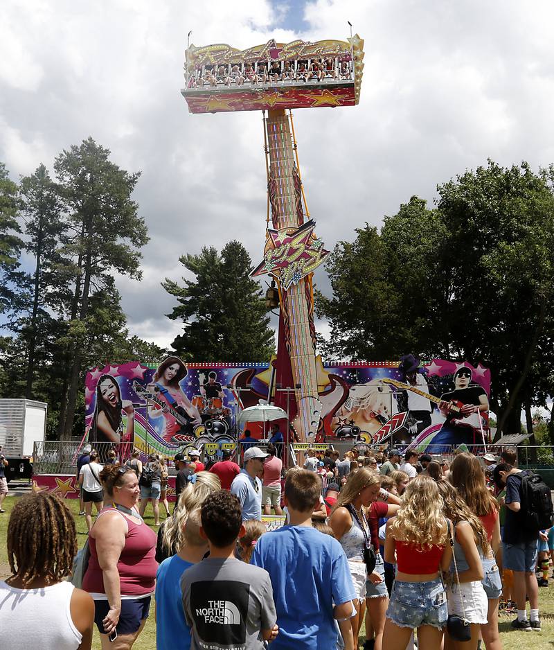 People wait to ride on the Rock Star during Lakeside Festival on Friday, July 5, 2024, at the Dole.