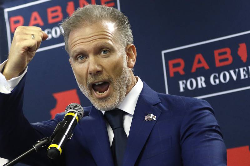 Gary Rabine pumps his fist as he chants his campaign slogan, "paving the way to stay," during an official announcement of his candidacy for governor of Illinois on Tuesday, March 30, 2021, at The Rabine Group in Schaumburg.