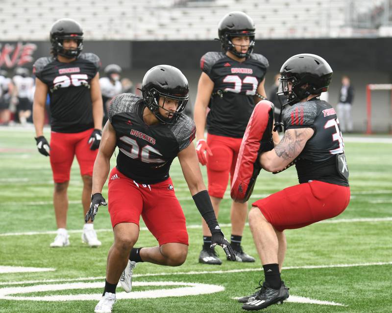 Jaden Dolphin, left, a defenseman for Northern Illinois University works on some drills during practice along with teammate Quinn Urwiler on Saturday March 30, 2024, held at Huskie Stadium in DeKalb.
