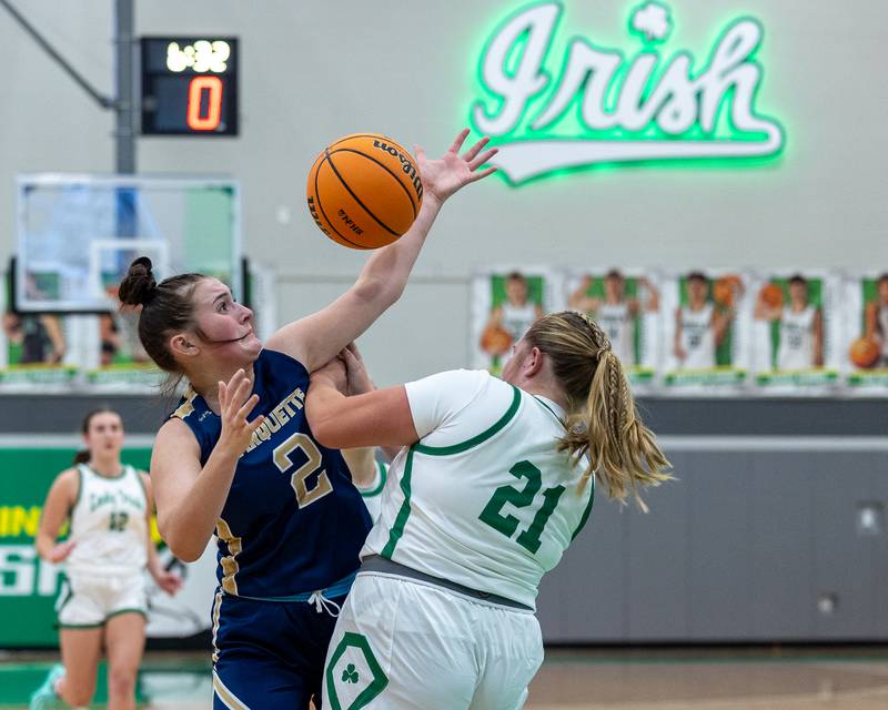 Kinley Rick (2) of Marquette reaches for ball as Camryn Stecken (21) of Seneca pushes her away on Monday, November 17, 2025 at Seneca High School in Seneca.