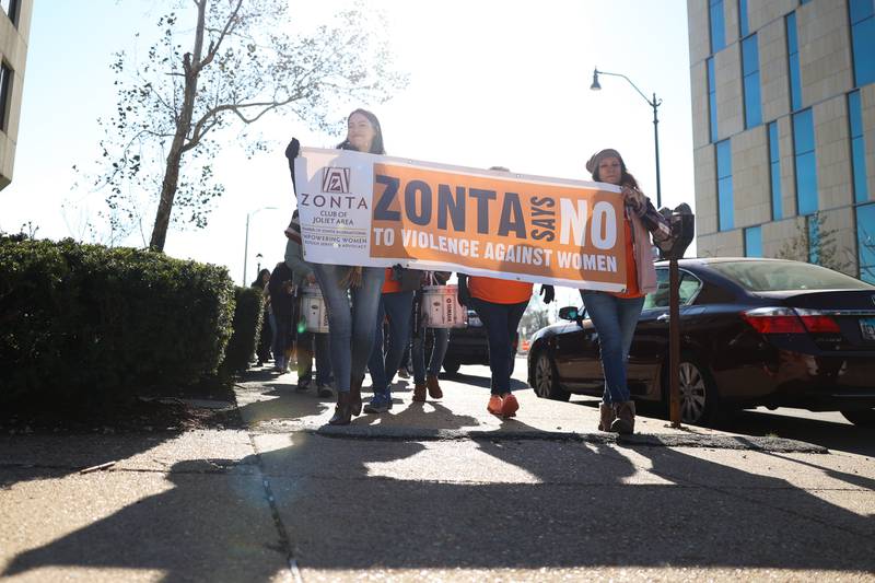 Supporters march around the old court house during a rally for ZONTA Says No To Violence Against Women on Tuesday in Joliet.